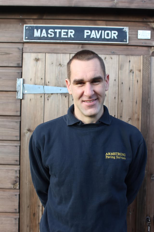 Armstrong Paving Services in branded workwear beneath a Master Pavior sign